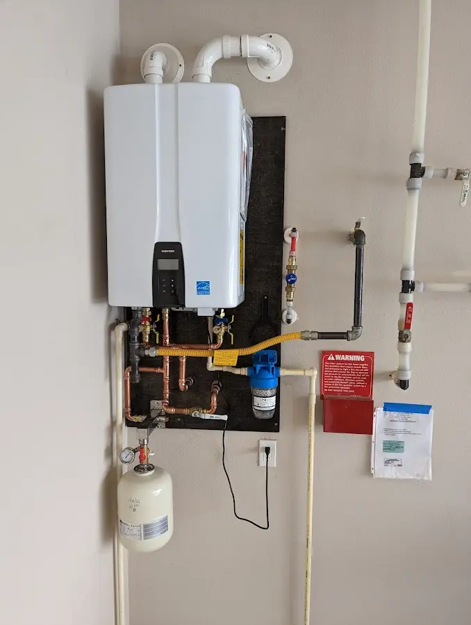 Professional plumber installing copper piping in a Bartonville home